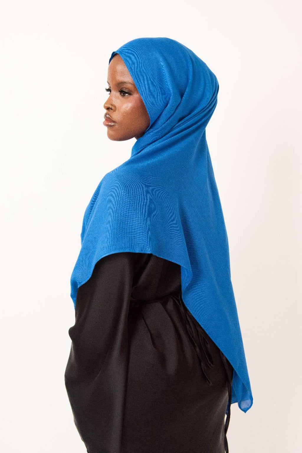 Royal blue modal hijab with matching jersey undercap - soft lightweight 100% modal fabric UK
Woman wearing royal blue hijab draped elegantly - modest fashion style UK
Royal blue modal scarf 180x100cm - breathable high-quality hijab with undercap
Close-up royal blue modal hijab fabric texture - luxurious soft drape
Royal blue hijab set - modal scarf and matching cotton jersey undercap UK