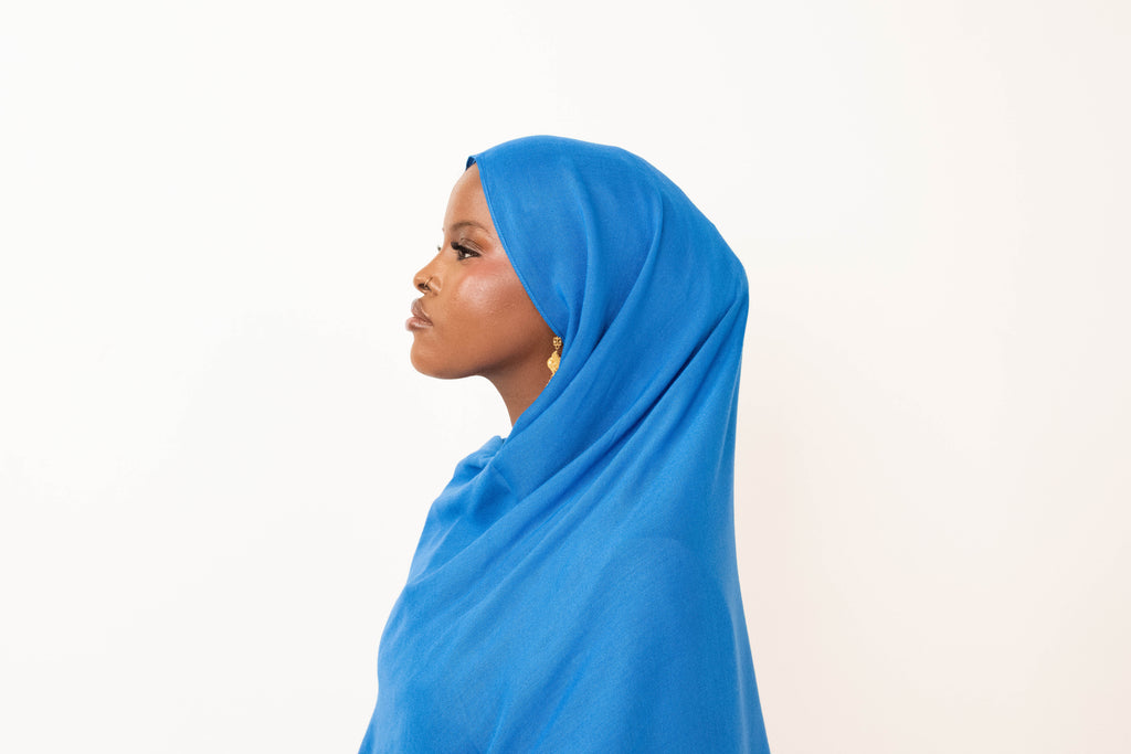 Royal blue modal hijab with matching jersey undercap - soft lightweight 100% modal fabric UK
Woman wearing royal blue hijab draped elegantly - modest fashion style UK
Royal blue modal scarf 180x100cm - breathable high-quality hijab with undercap
Close-up royal blue modal hijab fabric texture - luxurious soft drape
Royal blue hijab set - modal scarf and matching cotton jersey undercap UK