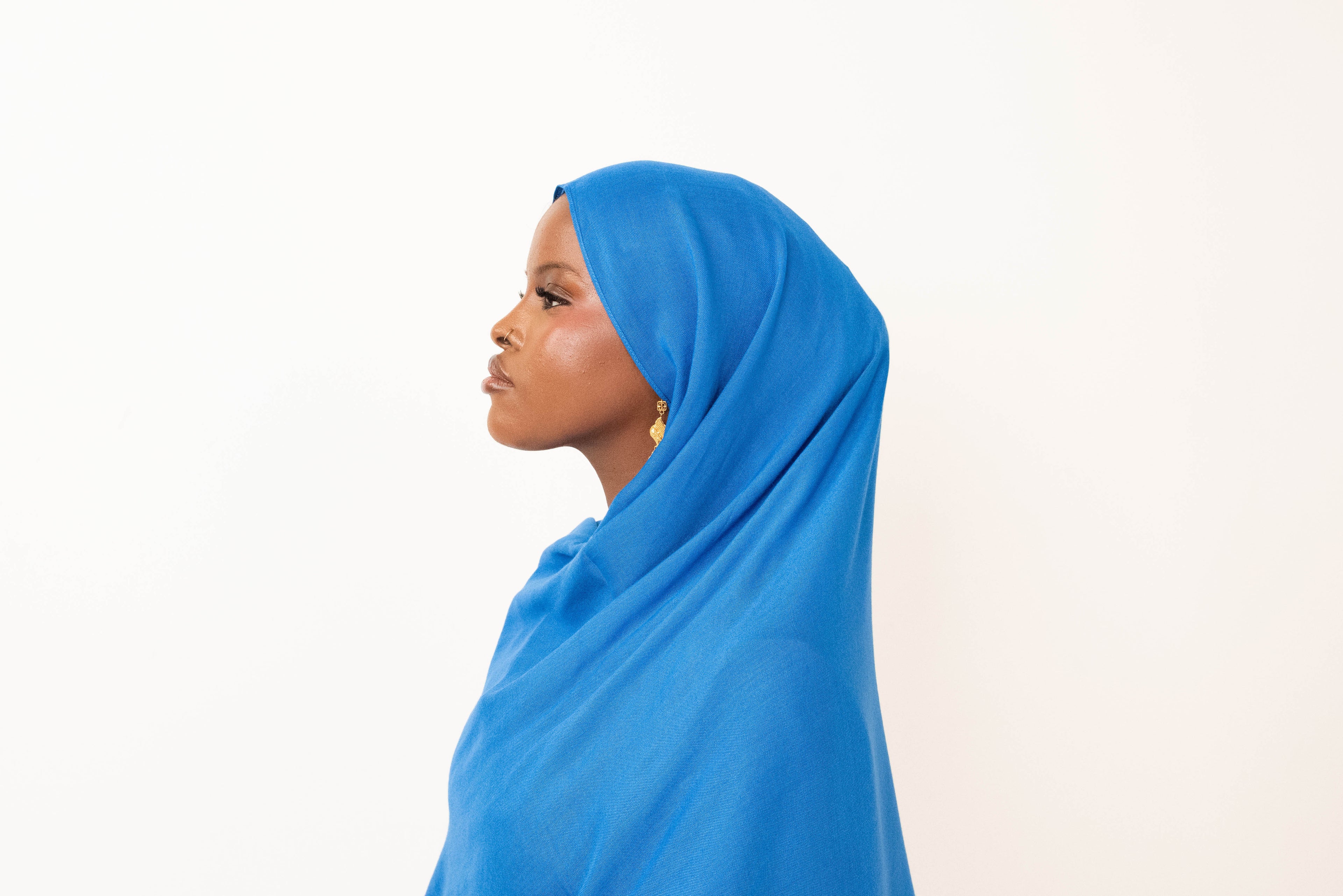 Royal blue modal hijab with matching jersey undercap - soft lightweight 100% modal fabric UK
Woman wearing royal blue hijab draped elegantly - modest fashion style UK
Royal blue modal scarf 180x100cm - breathable high-quality hijab with undercap
Close-up royal blue modal hijab fabric texture - luxurious soft drape
Royal blue hijab set - modal scarf and matching cotton jersey undercap UK
