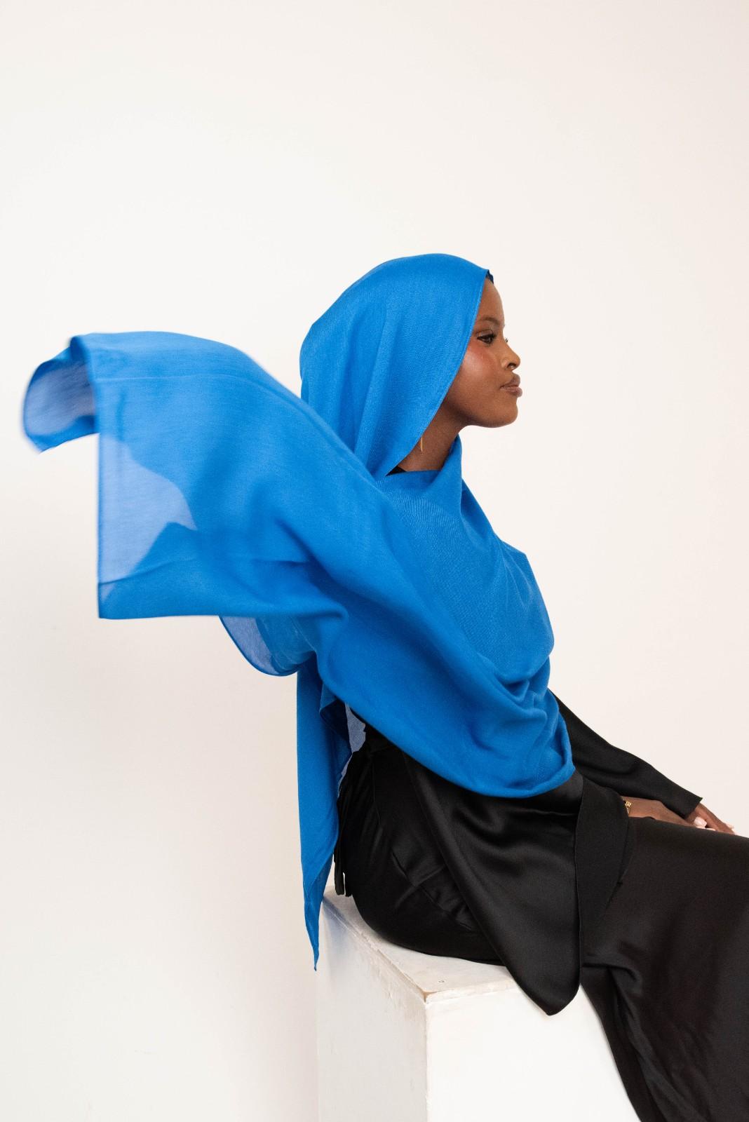 Royal blue modal hijab with matching jersey undercap - soft lightweight 100% modal fabric UK
Woman wearing royal blue hijab draped elegantly - modest fashion style UK
Royal blue modal scarf 180x100cm - breathable high-quality hijab with undercap
Close-up royal blue modal hijab fabric texture - luxurious soft drape
Royal blue hijab set - modal scarf and matching cotton jersey undercap UK