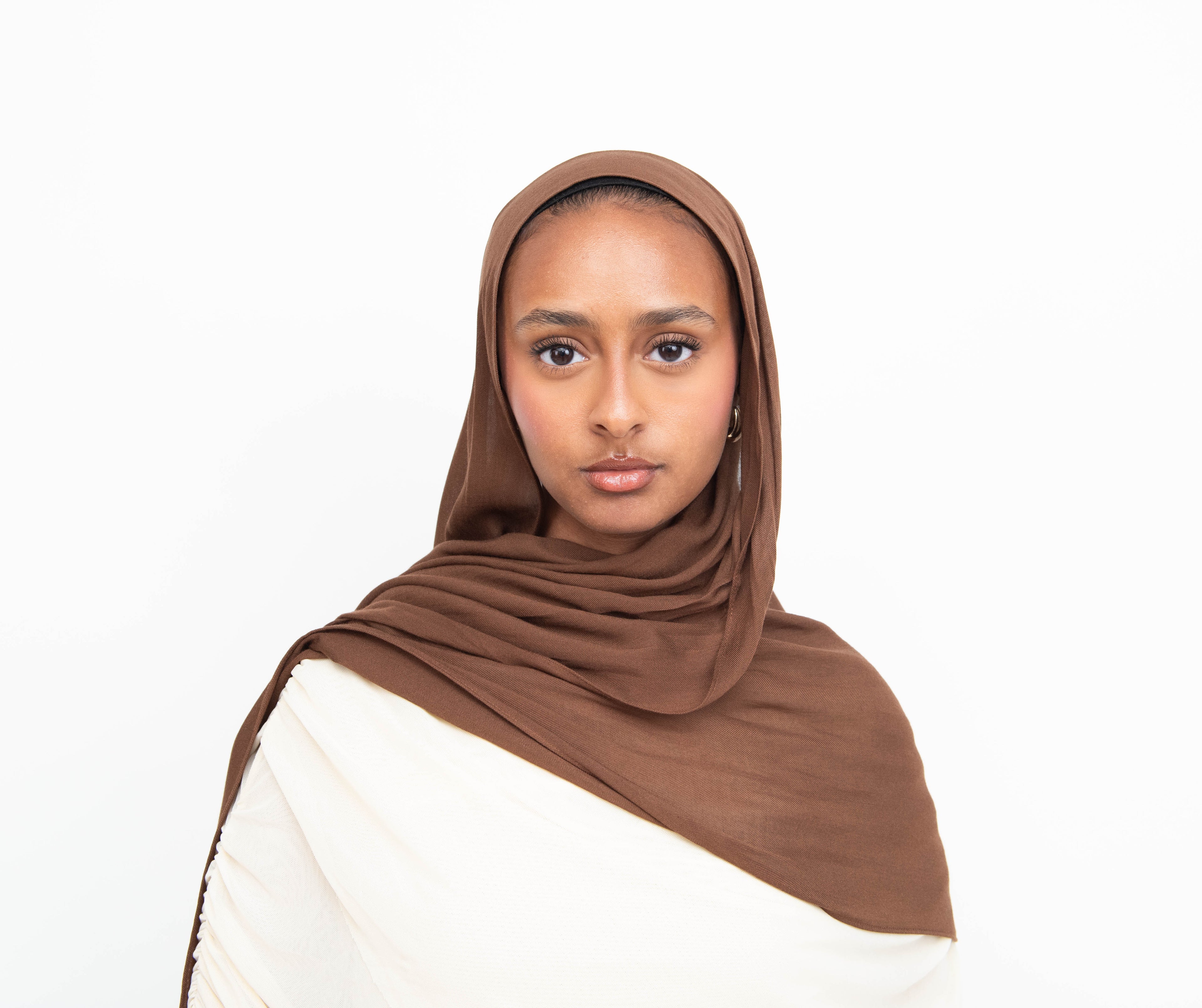 Chocolate brown modal hijab with matching undercap - soft lightweight fabric
Woman wearing chocolate brown hijab - elegant modest fashion
Chocolate brown modal scarf 180x100cm - breathable high-quality hijab
Close-up chocolate brown modal hijab fabric drape - luxurious texture
Chocolate brown hijab and jersey undercap set - everyday modest wear