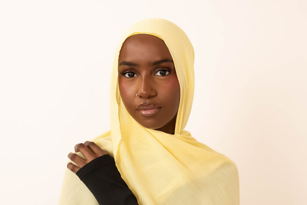 Butter yellow modal hijab with matching jersey undercap - soft lightweight 100% modal fabric UK
Woman wearing butter yellow hijab draped elegantly - modest fashion style UK
Butter yellow modal scarf 180x100cm - breathable high-quality hijab with undercap
Close-up butter yellow modal hijab fabric texture - luxurious soft drape
Butter yellow hijab set - modal scarf and matching cotton jersey undercap UK Butter yellow modal hijab styled for cheerful looks - sunny modest outfit inspiration
Bright butter yellow 