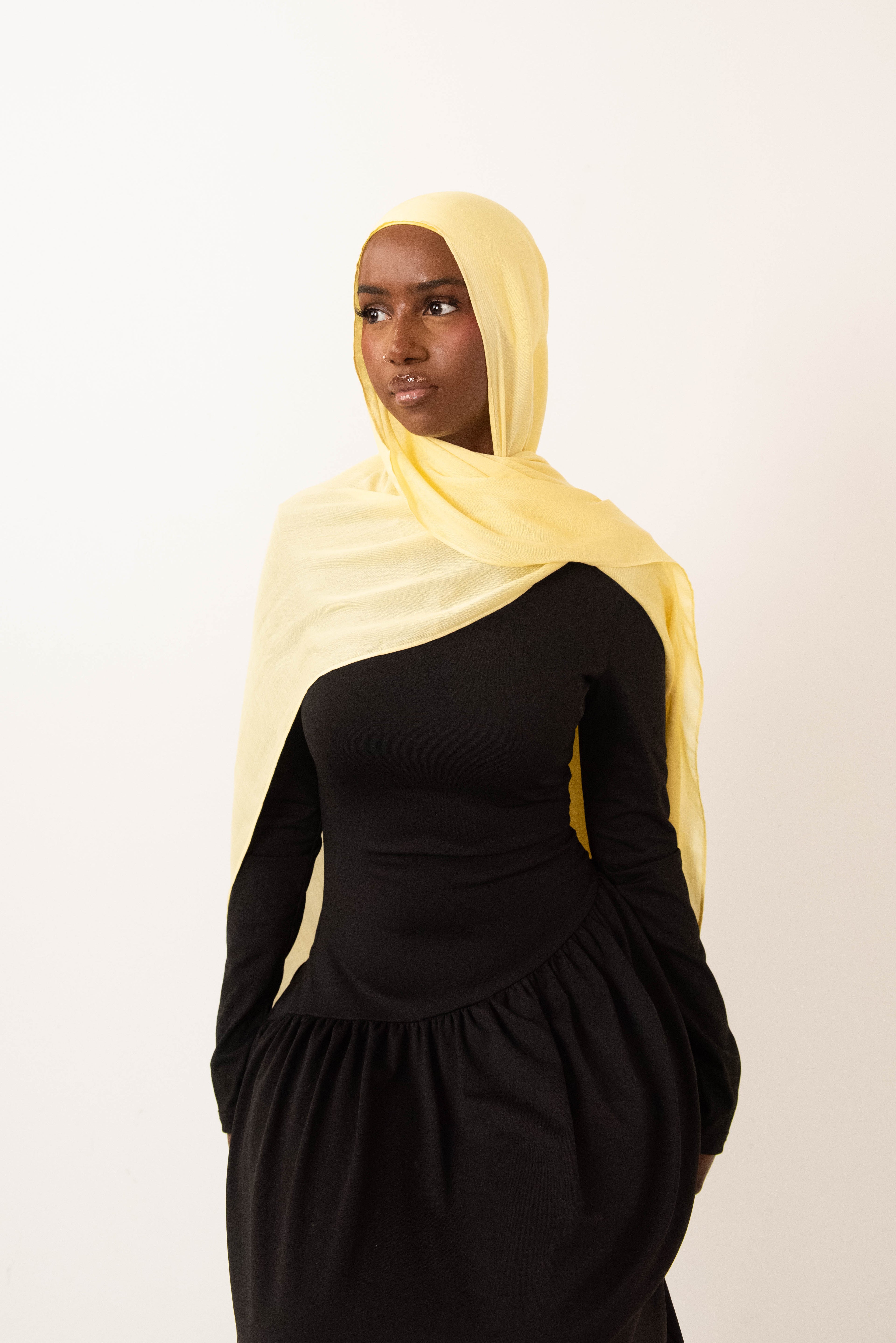 Butter yellow modal hijab with matching jersey undercap - soft lightweight 100% modal fabric UK
Woman wearing butter yellow hijab draped elegantly - modest fashion style UK
Butter yellow modal scarf 180x100cm - breathable high-quality hijab with undercap
Close-up butter yellow modal hijab fabric texture - luxurious soft drape
Butter yellow hijab set - modal scarf and matching cotton jersey undercap UK Butter yellow modal hijab styled for cheerful looks - sunny modest outfit inspiration
Bright butter yellow 
