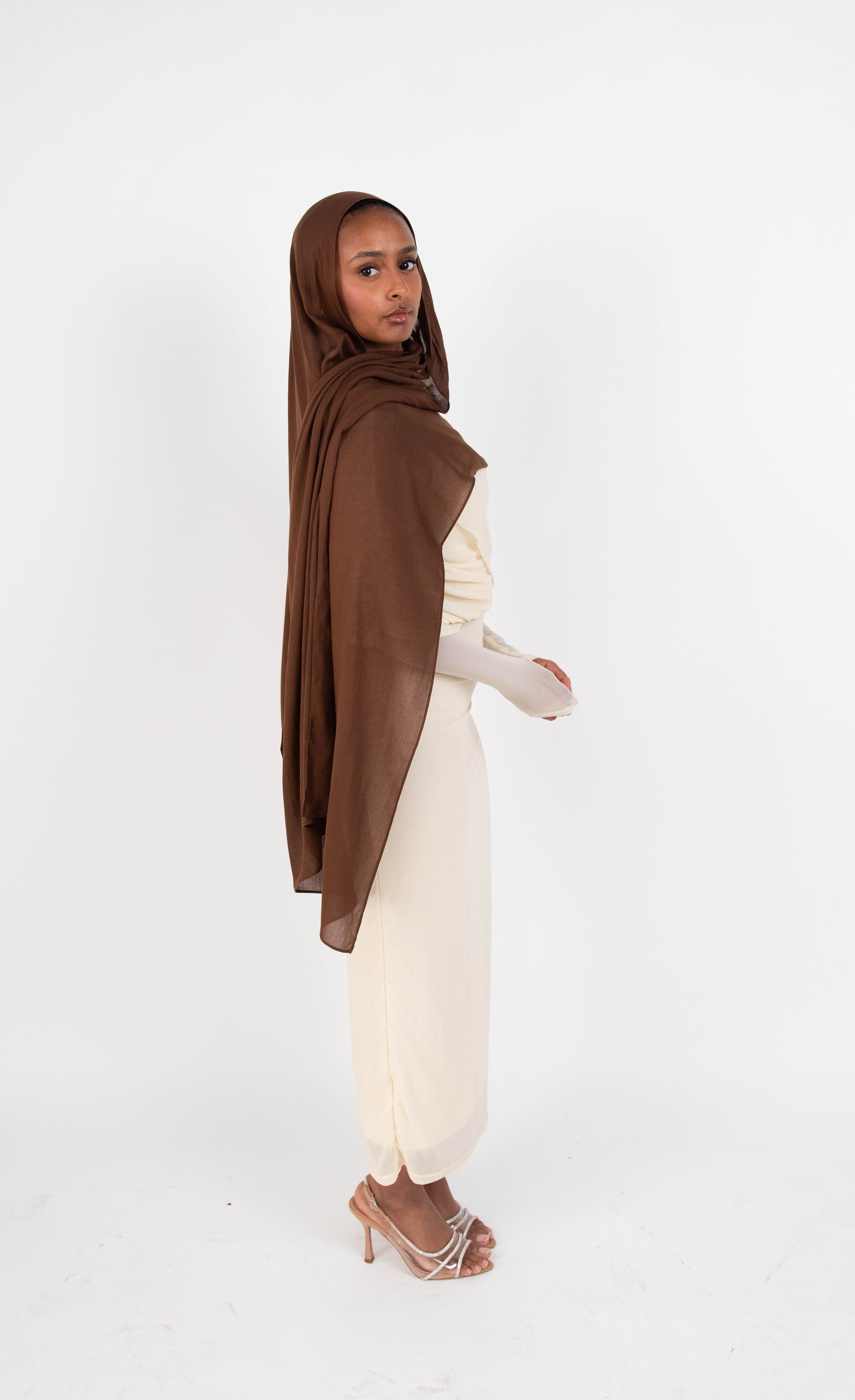 Chocolate brown modal hijab with matching undercap - soft lightweight fabric
Woman wearing chocolate brown hijab - elegant modest fashion
Chocolate brown modal scarf 180x100cm - breathable high-quality hijab
Close-up chocolate brown modal hijab fabric drape - luxurious texture
Chocolate brown hijab and jersey undercap set - everyday modest wear