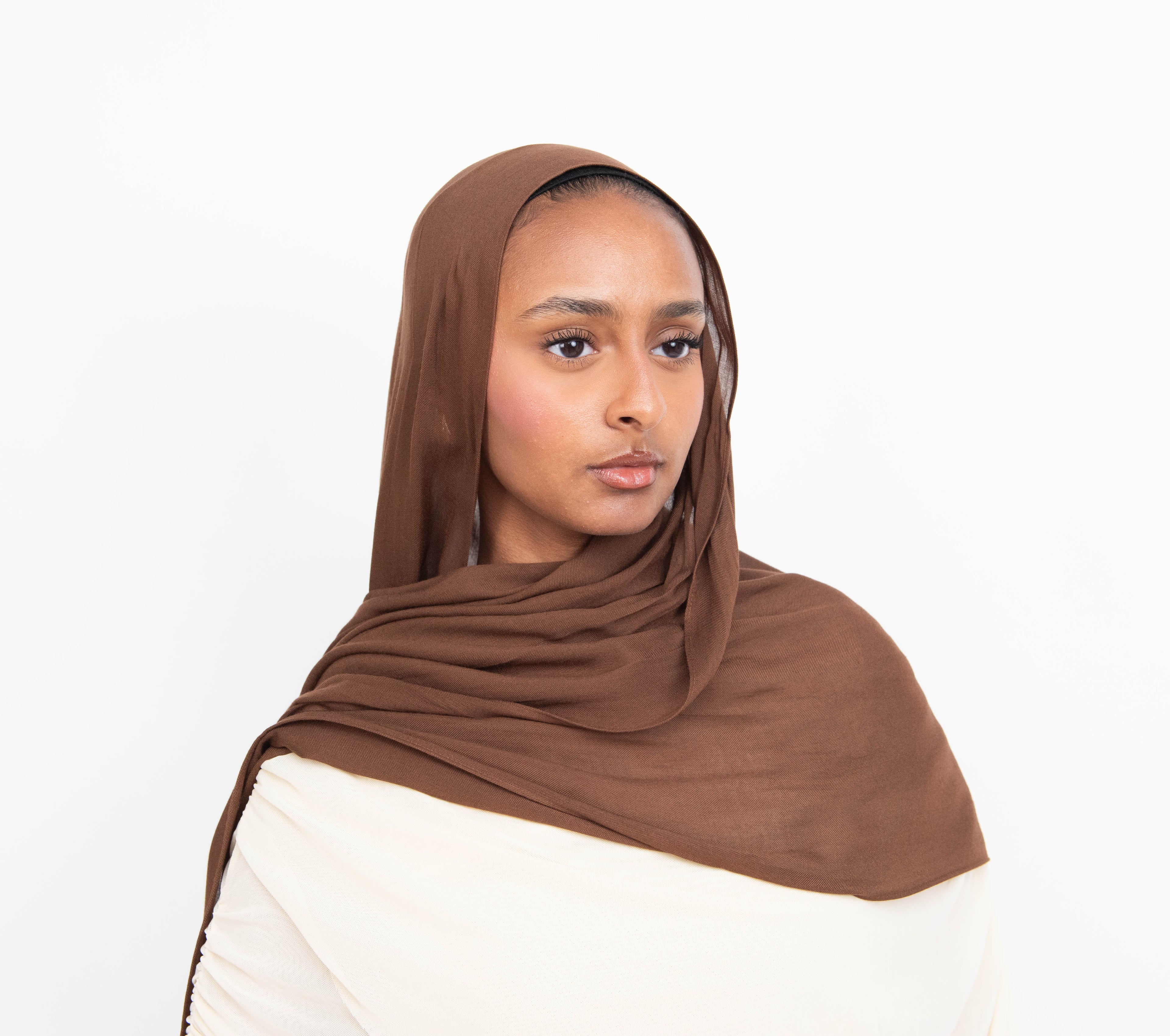 Chocolate brown modal hijab with matching undercap - soft lightweight fabric
Woman wearing chocolate brown hijab - elegant modest fashion
Chocolate brown modal scarf 180x100cm - breathable high-quality hijab
Close-up chocolate brown modal hijab fabric drape - luxurious texture
Chocolate brown hijab and jersey undercap set - everyday modest wear